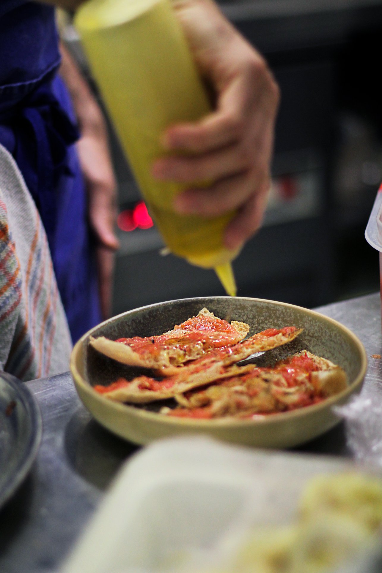 Chef finishing pintxos in a San Sebastián kitchen