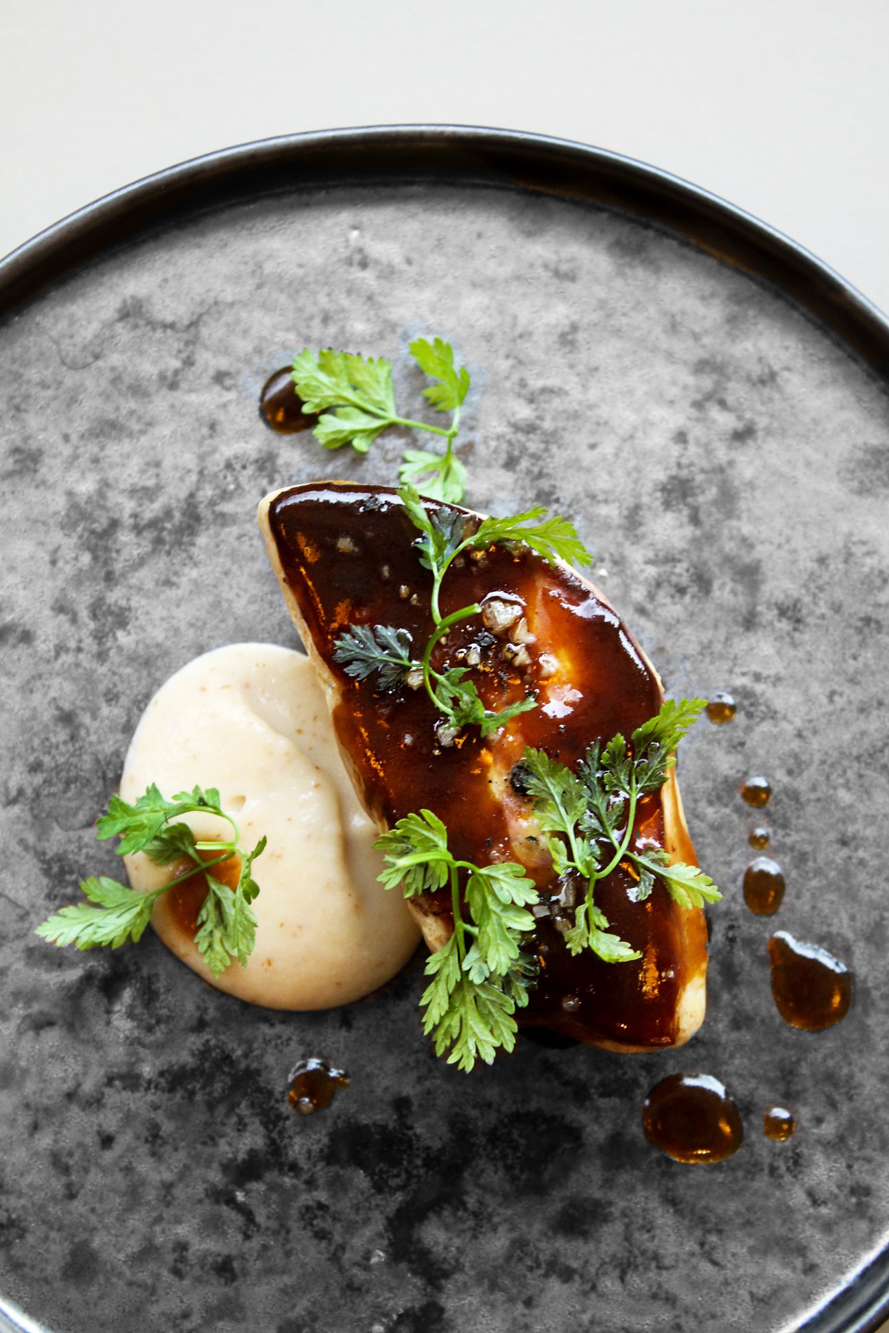Plated foie gras with parsley at a San Sebastián restaurant