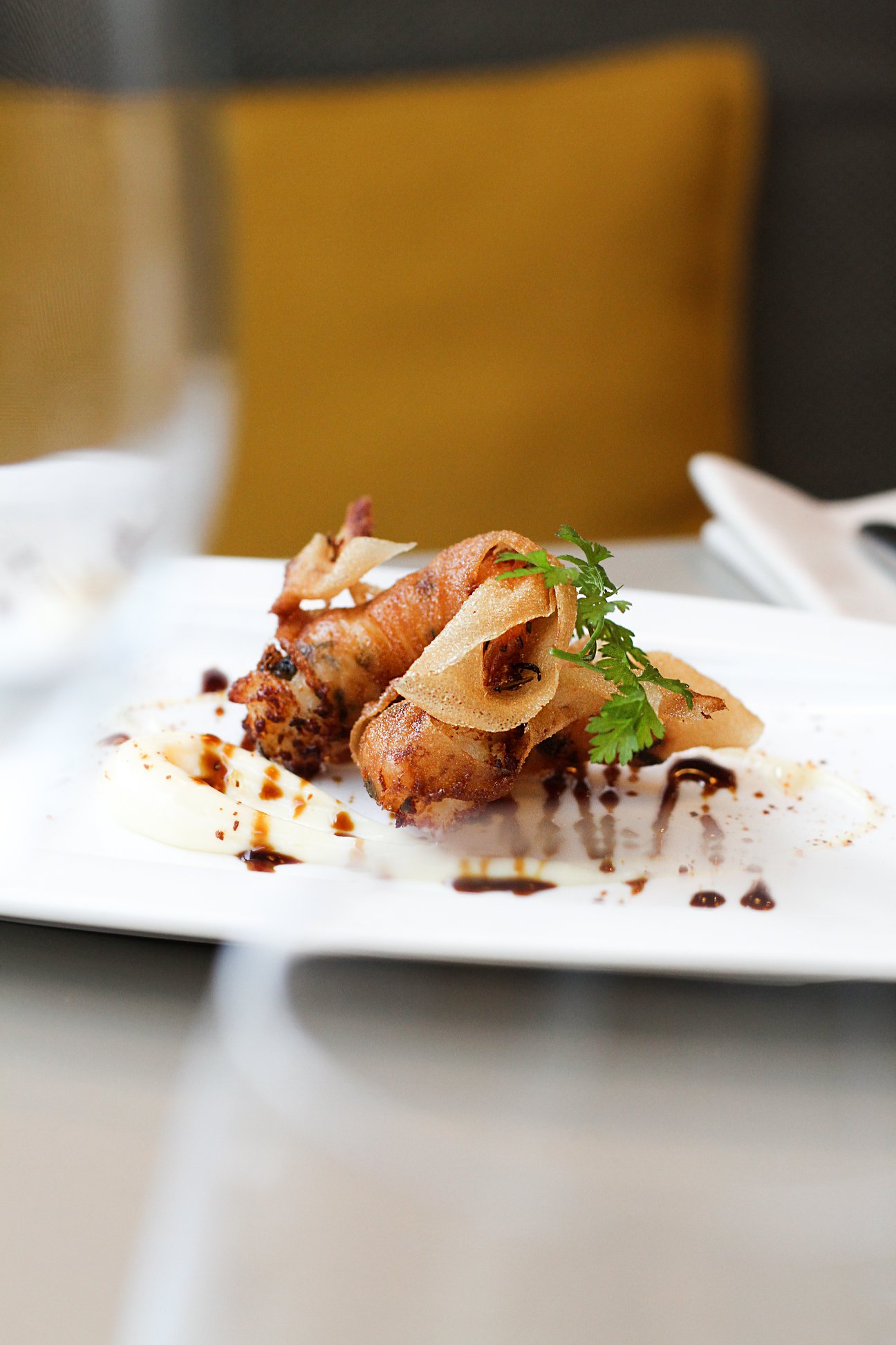 Plated pintxo with crisp garnish at a San Sebastián bar