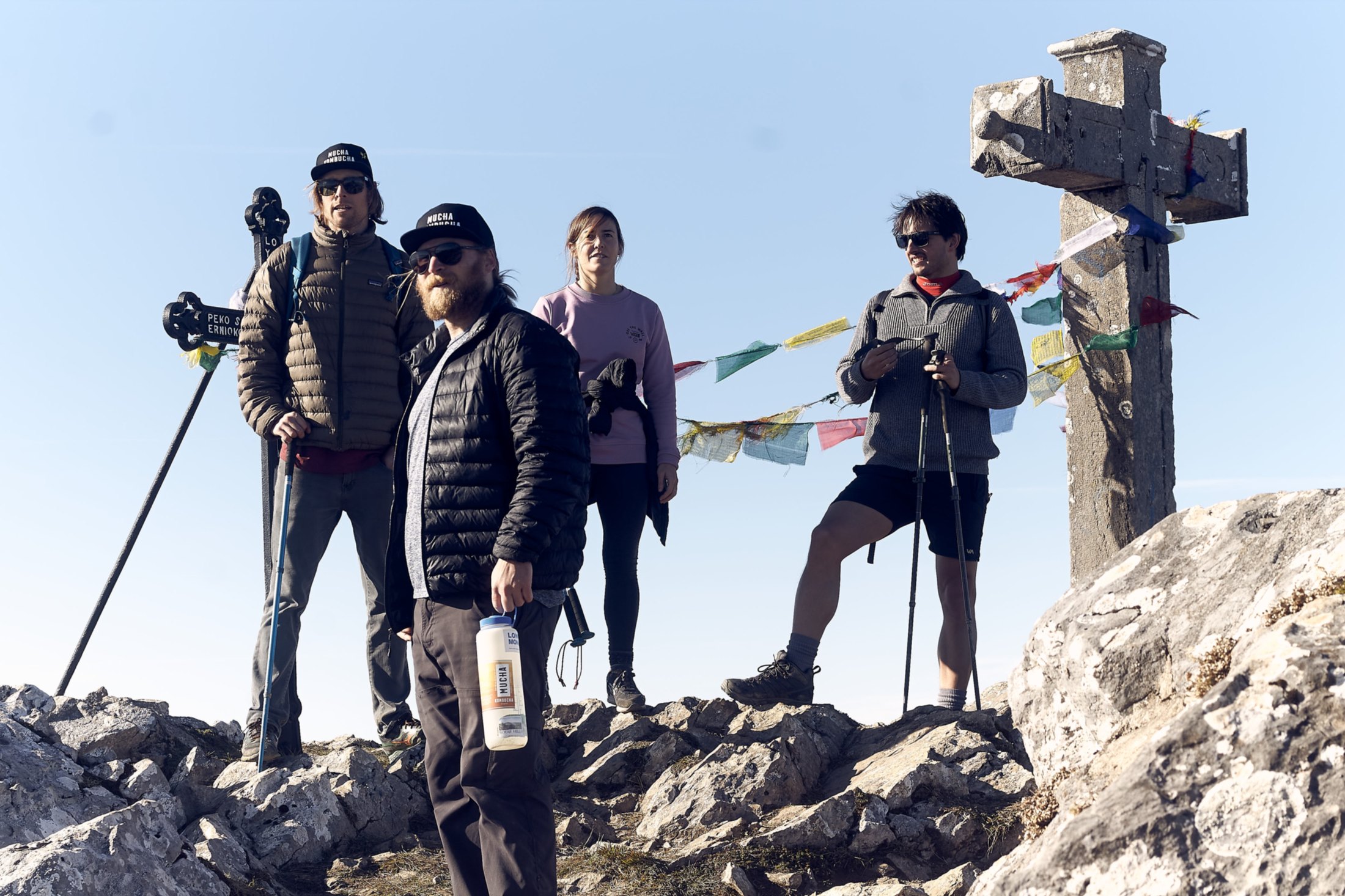 Hikers at the summit cross on Hernio in the Basque Country